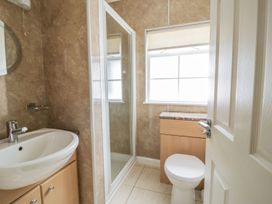 A bathroom with a sink, toilet and shower at Cottage No 9 in Keswick
