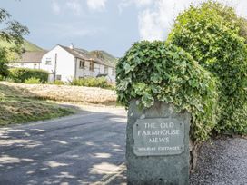 An entrance sign for The Old Farmhouse Mews Holiday Cottages in Keswick