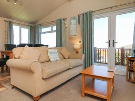 A living room with a sofa and coffee table at 1 Ocean Terrace in Ilfracombe