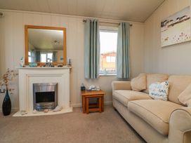 A living room with a couch and a fireplace at 1 Ocean Terrace Ilfracombe