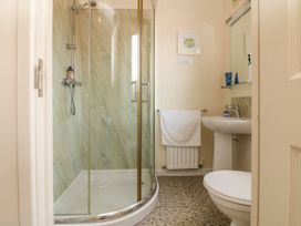 A bathroom with a shower toilet and sink at 1 Ocean Terrace Ilfracombe