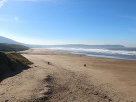 A beach with sand and ocean waves at 1 Ocean Terrace Ilfracombe