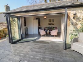 A snug with chairs and table visible through open doors at The Summerhouse