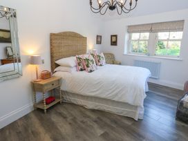 A bedroom with a bed and a bedside table at The Summerhouse 