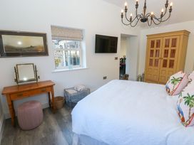 A bedroom with a bed and a wardrobe at The Summerhouse 