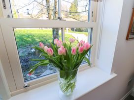 A vase of pink tulips on a windowsill at The Summerhouse
