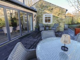 An outdoor seating area with a table and chairs at The Summerhouse in 