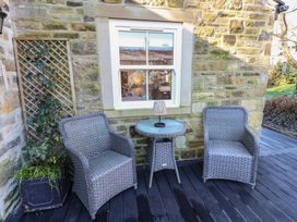 A garden area with two chairs and a table outside at The Summerhouse 