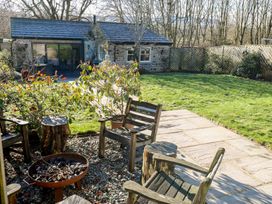 A garden with wooden chairs and a fire pit at The Summerhouse in 
