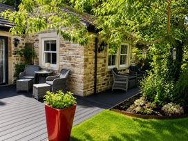 An outdoor seating area with chairs and a table at The Summerhouse Kildwick