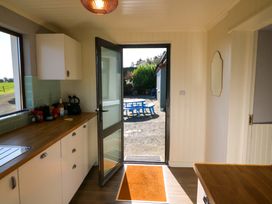 A kitchen with a door leading outside at Thadg and Hannah’s in Miltown