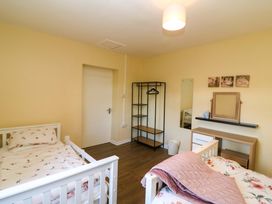 A bedroom with two beds and a mirror at Thadg and Hannah’s in Miltown