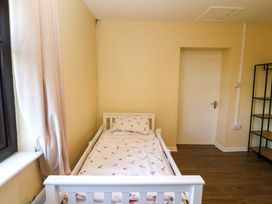 A bedroom with a bed and a shelf at Thadg and Hannah’s in Miltown