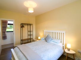A bedroom with a bed and bedside table at Thadg and Hannah’s in Miltown