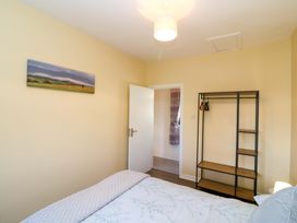 A bedroom with a bed and wardrobe at Thadg and Hannah’s in Miltown