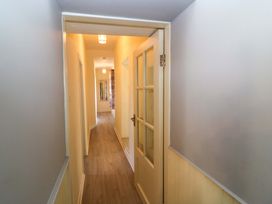 A hallway with a door and light fixtures at Thadg and Hannah’s in Miltown