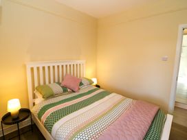 A bedroom with a bed and nightstand at Thadg and Hannah’s in Miltown