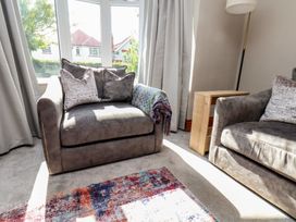 A living room with an armchair and sofa at 44 Love Lane, Whitby