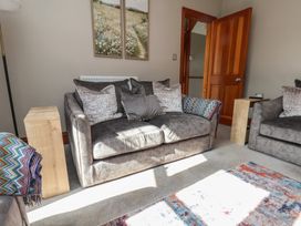 A living room with a sofa and side table at 44 Love Lane in Whitby