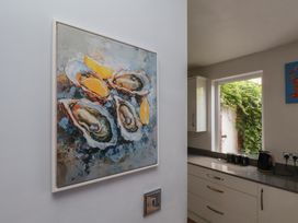 A kitchen with an oyster painting and a window at 44 Love Lane in Whitby