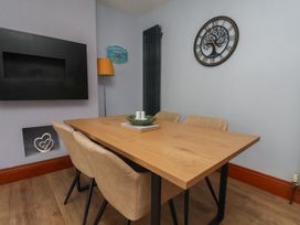 A dining room with a table and chairs at 44 Love Lane in Whitby