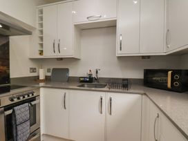 A kitchen with cabinets, sink, oven, and microwave at 44 Love Lane Whitby