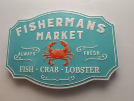 A sign for a fish market featuring a crab at 44 Love Lane, Whitby