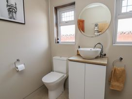 A bathroom with a toilet and sink at 44 Love Lane in Whitby