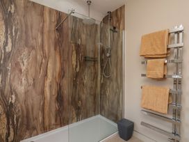 A bathroom with a shower and towel rack at 44 Love Lane in Whitby