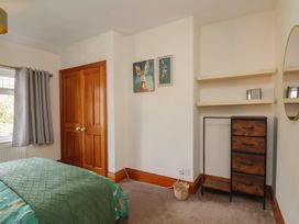 A bedroom with a bed and wardrobe at 44 Love Lane in Whitby
