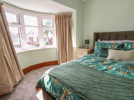 A bedroom with a bed and bedside table at 44 Love Lane in Whitby