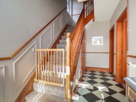 A staircase with a baby gate in a hallway at 44 Love Lane, Whitby