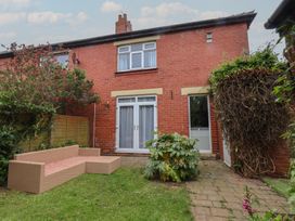 A garden with a bench and plants at 44 Love Lane in Whitby