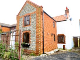 A house with a brick exterior and windows at Mabby in Great Yarmouth