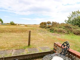 A garden view with grass and bushes at Mabby, Great Yarmouth