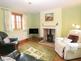 A living room with a fireplace and couch at Mabby in Caister-On-Sea