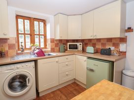 A kitchen with a window, sink, and appliances at Mabby in Caister-On-Sea