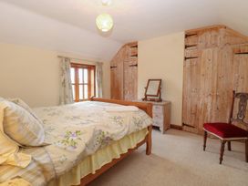 A bedroom with a bed and dresser at Mabby in Caister-On-Sea