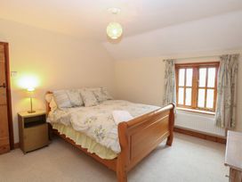 A bedroom with a bed and window at Mabby in Caister-On-Sea