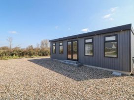 A cabin exterior with a gravel area at Binevenagh Point Cabin