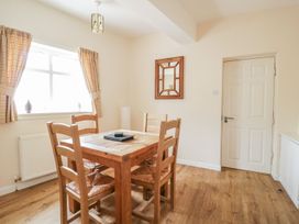 A dining room with a wooden table and chairs at No 8- Farmhouse Retreat in Keswick