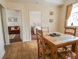 A dining room with a wooden table and chairs at No 8- Farmhouse Retreat in Keswick