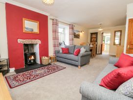 A living room with a fireplace and sofas at Yewbarrow in Seascale