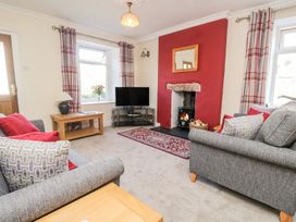 A living room with a television and fireplace at Yewbarrow Seascale