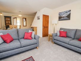 A living room with sofas and a table at Yewbarrow in Seascale