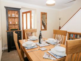 A dining room with a table set for a meal at Yewbarrow in Seascale