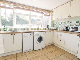 A kitchen with a washing machine and dishwasher at Yewbarrow Seascale