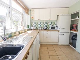 A kitchen with cabinets and appliances at Yewbarrow in Seascale
