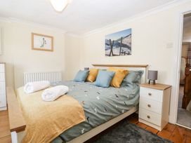 A bedroom with a bed and bedside table at Yewbarrow in Seascale