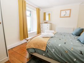 A bedroom with a bed and dresser at Yewbarrow in Seascale